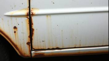 Rust repair on a white vehicle, showcasing meticulous restoration work.